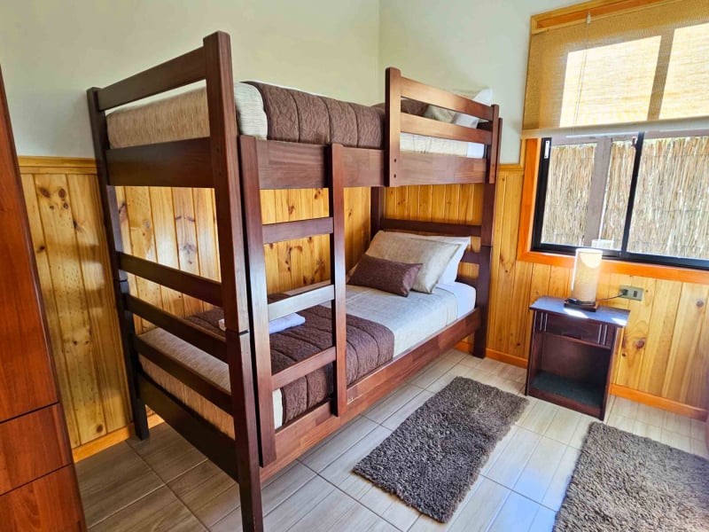 Bunk bed bedroom of the Superior Bungalow with pool view