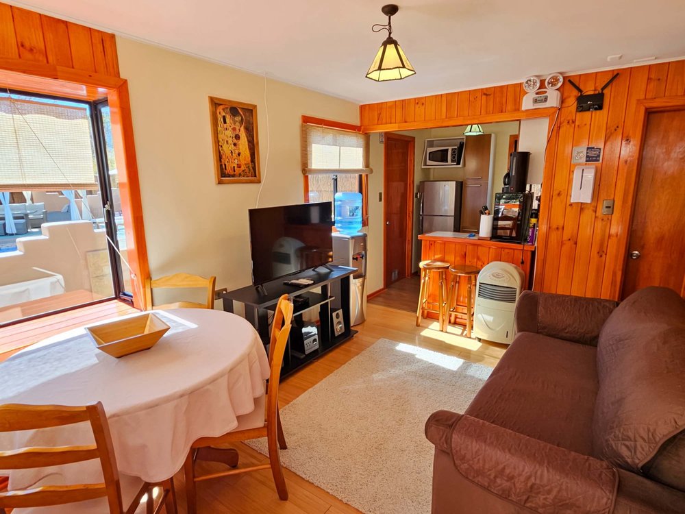 Living and dining area of the Elite Bungalow with pool view