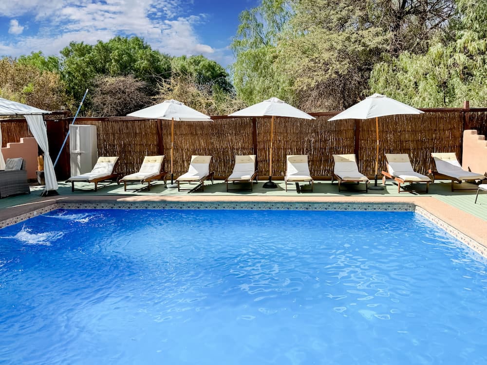 Pool with parasols and sun loungers