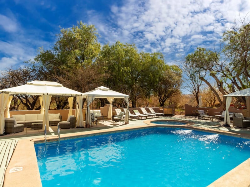 Pool with awnings and sun loungers