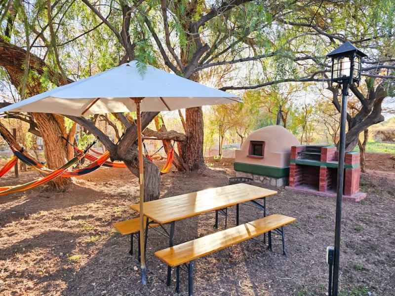 Table with parasol and clay oven