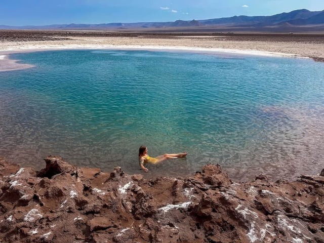 Person floating in a turquoise lagoon at Baltinache