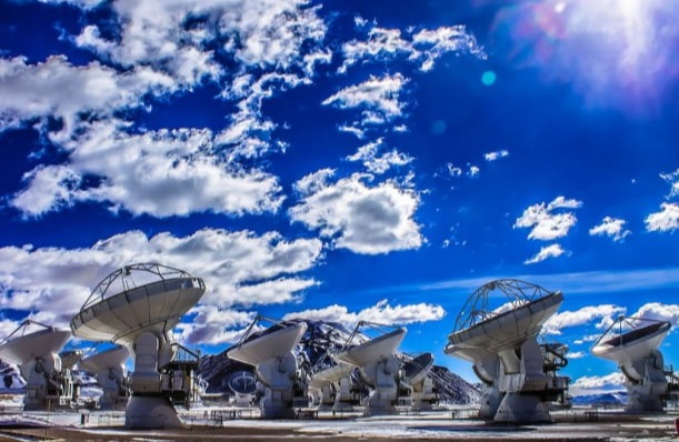 ALMA radio telescope antennas under a blue sky