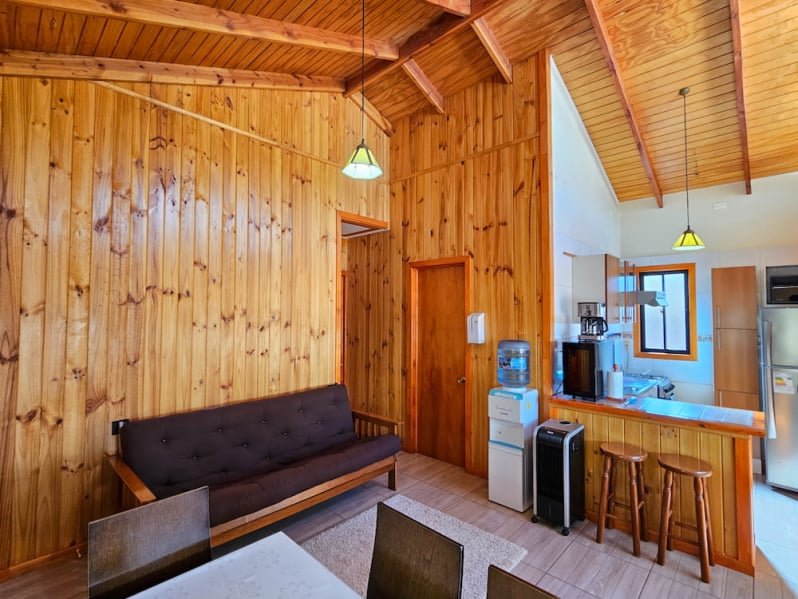 Wood-paneled living room with sofa and breakfast bar