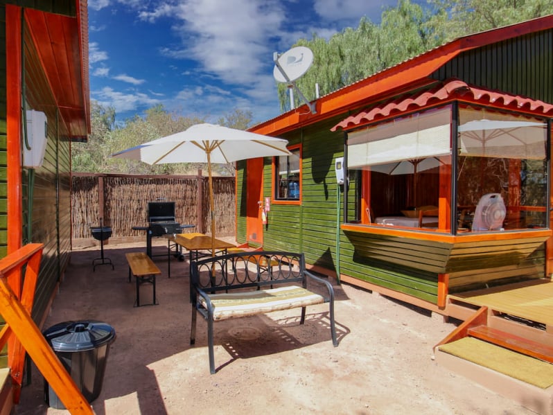 Cabin terrace with bench, grill and parasol