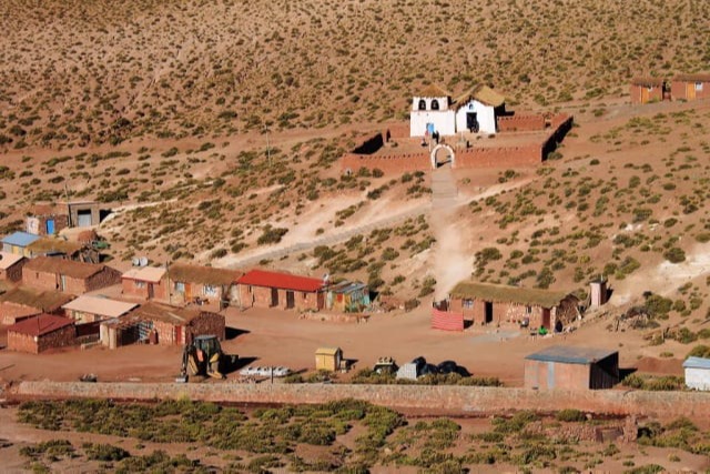 Houses and white chapel in the village of Machuca